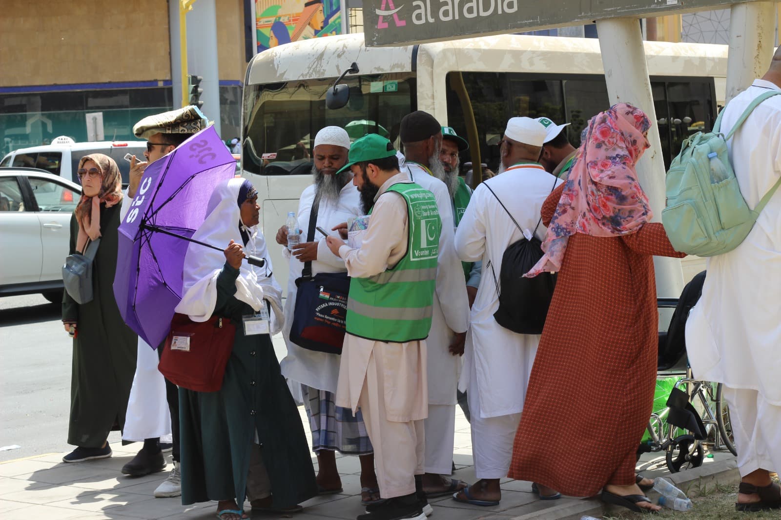 Volunteers assisting pilgrims at bus station